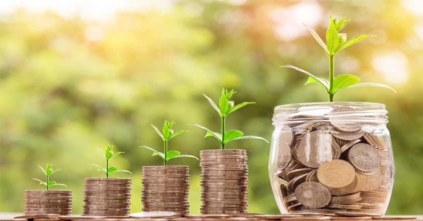 Money pot showed growing a plant with stacks of coins next to it showing the phenomenal rate of construction industry growth