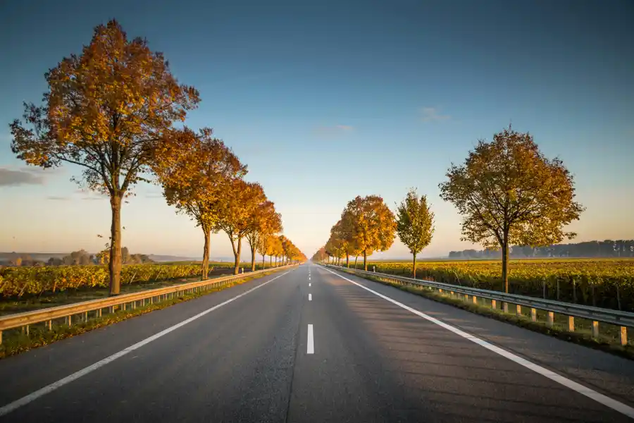 Demand beating supply HGV drivers needed written on a blue background and a road showing a heavy goods vehicle