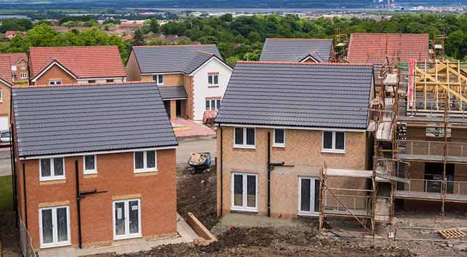 Housing Construction site showing 2 near finshed homes made with brick