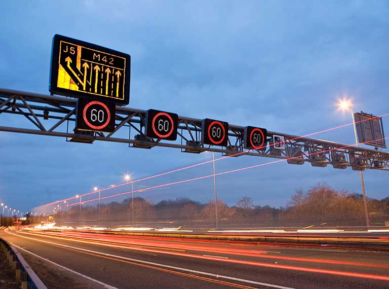 UK smart motorway image showing variable speed limit gantry