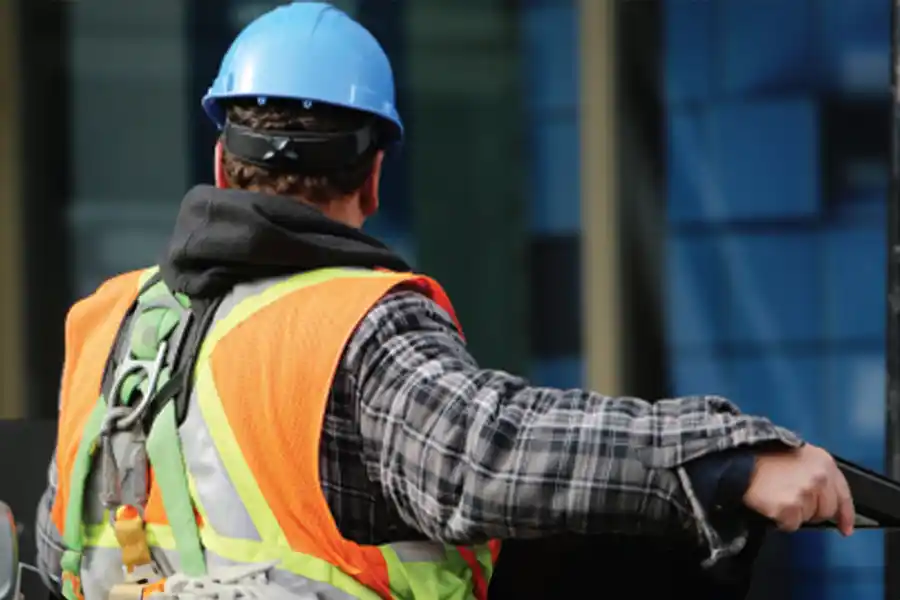 Construction worker wearing protective equipment on a construction site