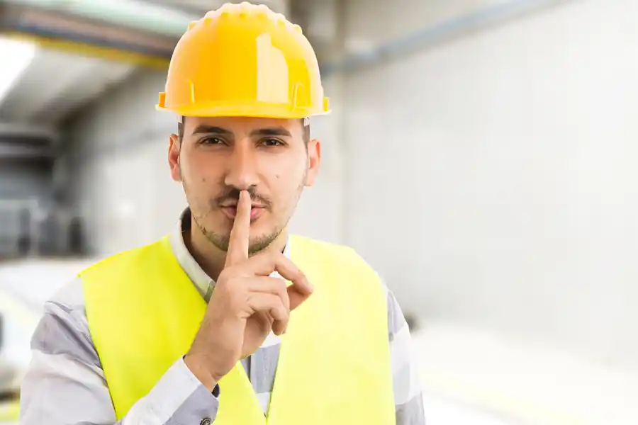 Construction Manager holding his finger to his mouth 