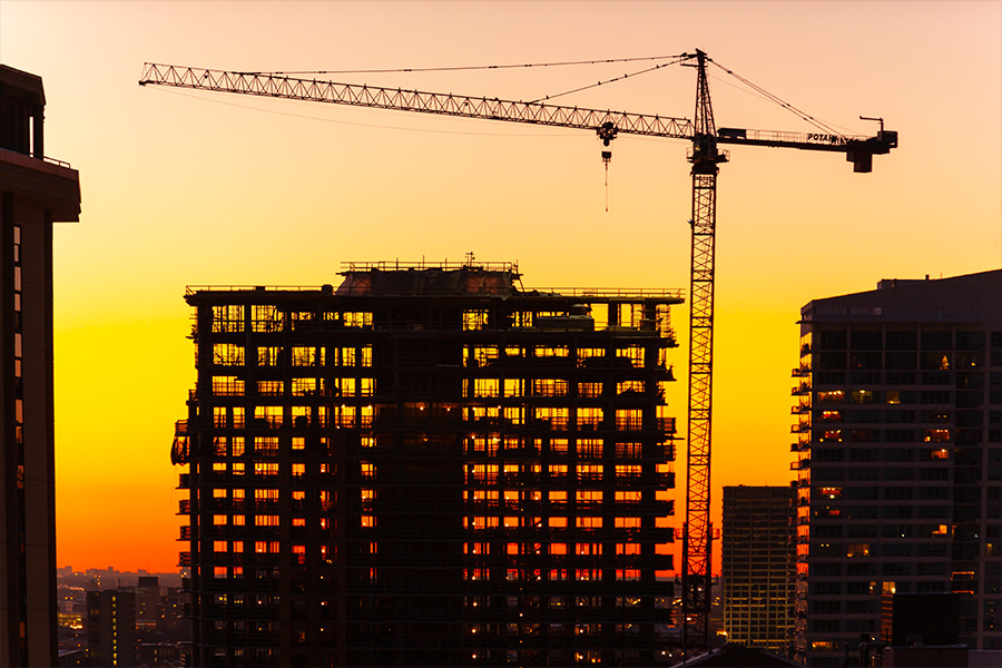 Construction cranes and city development in Birmingham-style urban setting
