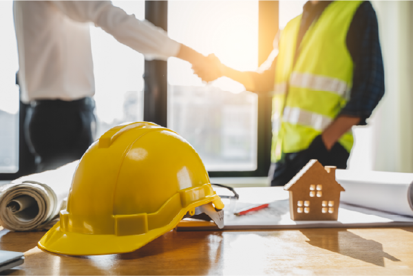 Construction worker shaking hands with a hiring manager during a construction worker shortage