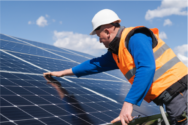 solar panel fitter fitting a solar panel in a solar farm to tackle decarbonisation