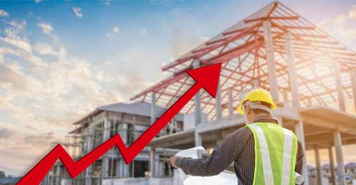 Construction Site worker with a cloudy day shown in the background with a large red arrow and line showing an upward trajectory