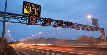 UK smart motorway image showing variable speed limit gantry
