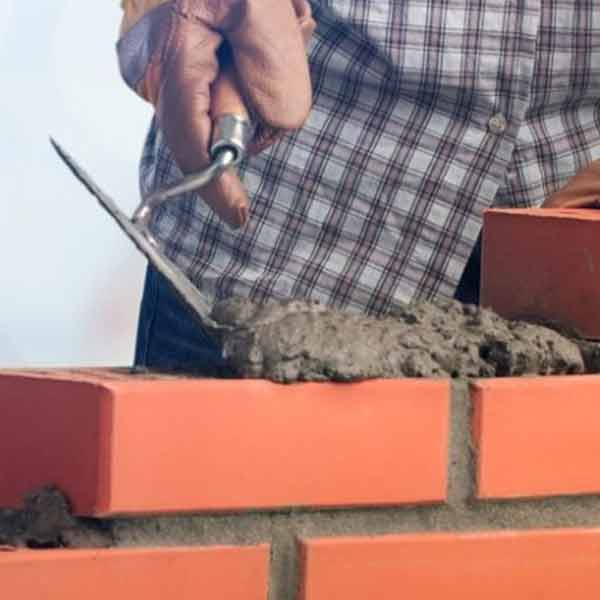 A square image showing a Bricklayer at work