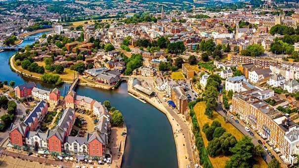 Aerial view of Exeter showing the winding river Exe with built up building surrounding it.