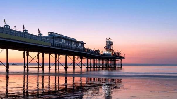 Paignton Beach and Pier during a red and orange sunset