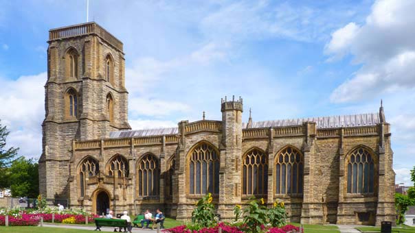 St John the Baptists Church in Yeovil in summer with blossoming flowers around